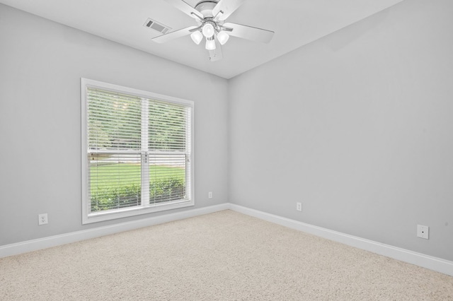 carpeted empty room featuring ceiling fan