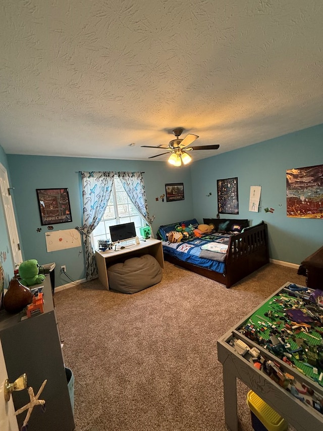 carpeted bedroom featuring ceiling fan and a textured ceiling