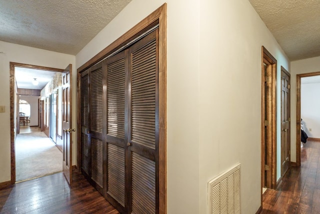 882 Gaissert Church Rd, Sparta, GA 31087 - hall with a textured ceiling and dark wood-type flooring