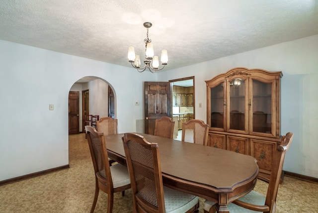 882 Gaissert Church Rd, Sparta, GA 31087 - carpeted dining area with a textured ceiling and a notable chandelier
