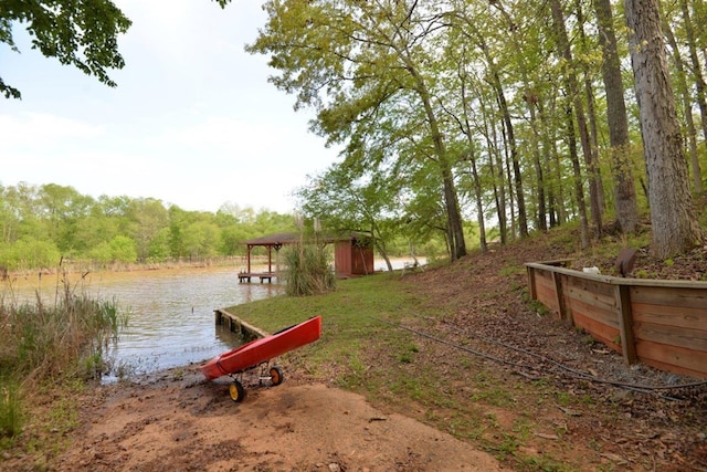 exterior space with a water view and a view of trees