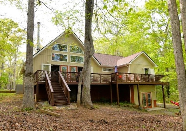rear view of house with french doors, stairway, and a deck