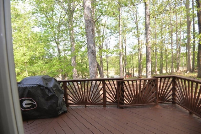 wooden terrace featuring a grill