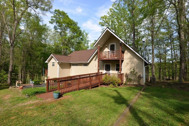back of house with cooling unit, a yard, a deck, and a balcony