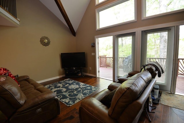 living area with wood finished floors, high vaulted ceiling, and baseboards