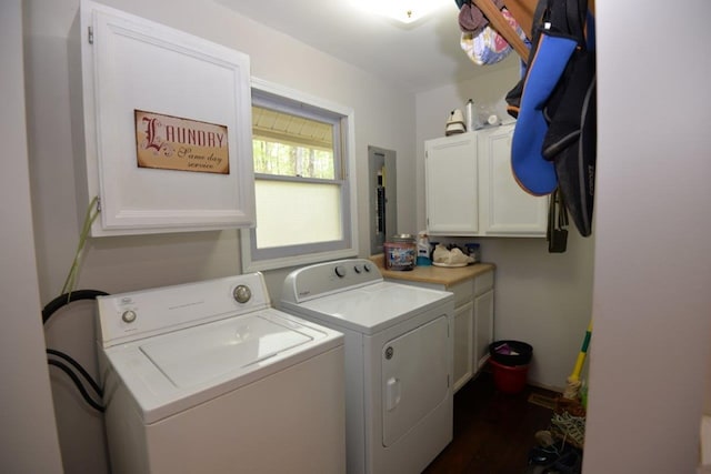 clothes washing area with dark wood-style flooring, independent washer and dryer, and cabinet space