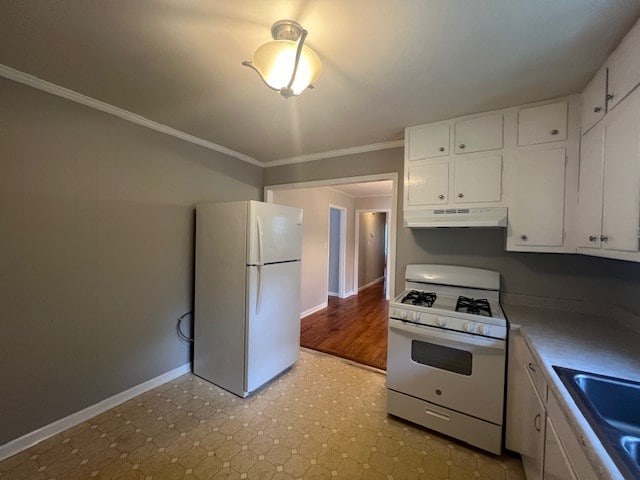 kitchen with crown molding, sink, white cabinets, and white appliances