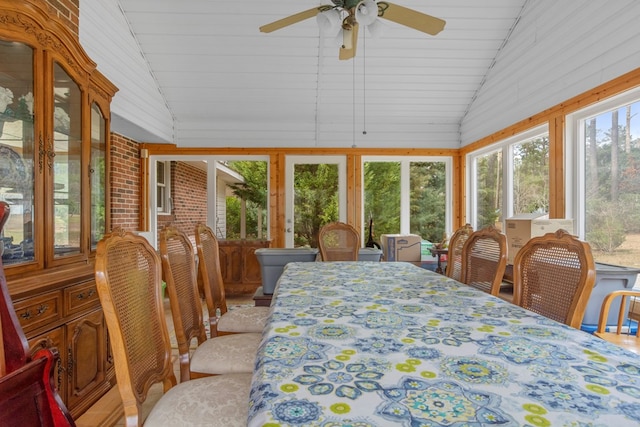 sunroom with ceiling fan and vaulted ceiling