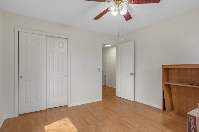 unfurnished bedroom with ceiling fan, light hardwood / wood-style floors, and a closet