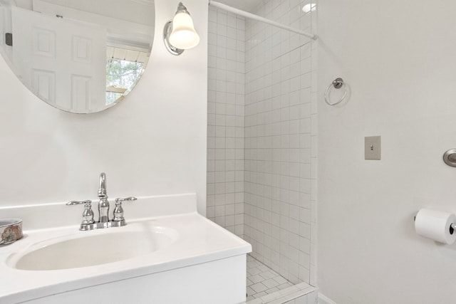 bathroom with vanity and tiled shower