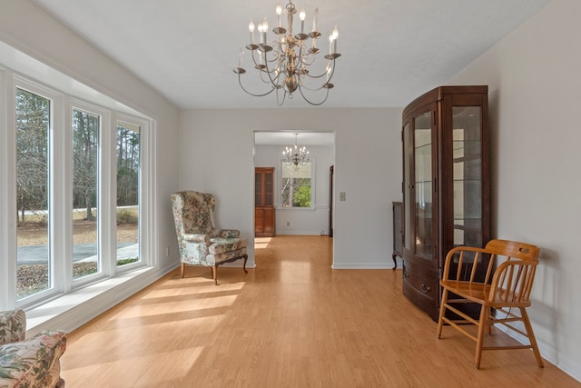 sitting room featuring light hardwood / wood-style floors and a chandelier