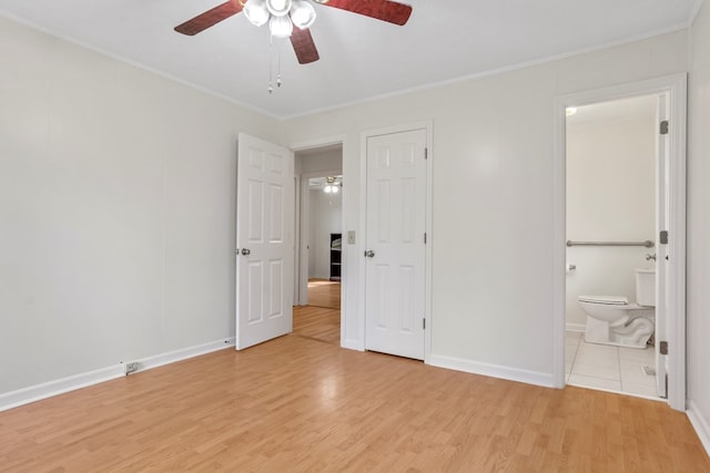 unfurnished bedroom featuring light wood-type flooring, crown molding, and ensuite bath