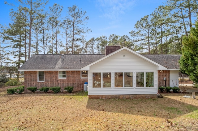 rear view of property with a lawn