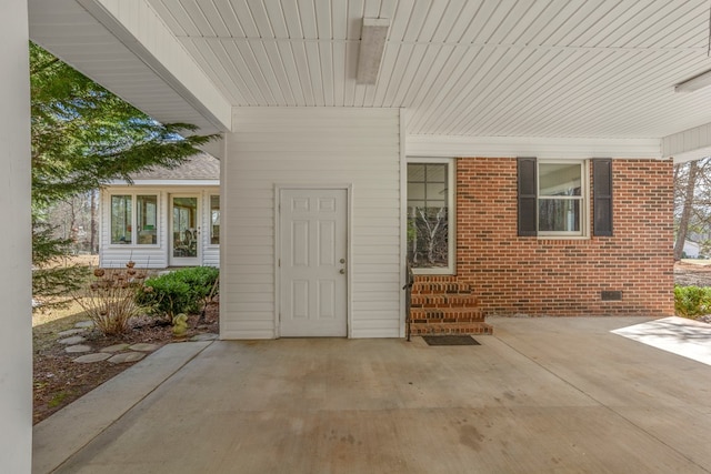 entrance to property featuring a patio