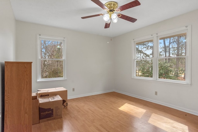 empty room with ceiling fan and light wood-type flooring