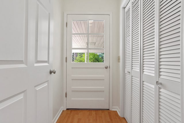 doorway to outside with light wood-type flooring