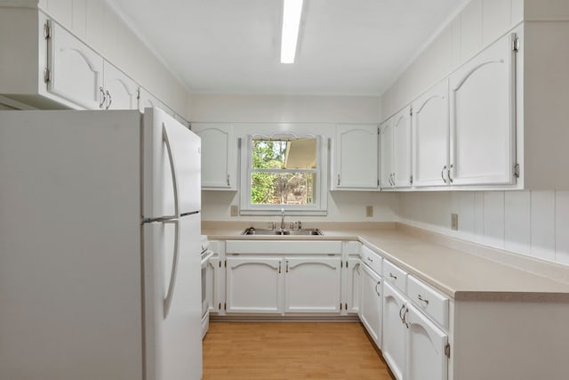 kitchen featuring white appliances, light wood-type flooring, white cabinets, crown molding, and sink