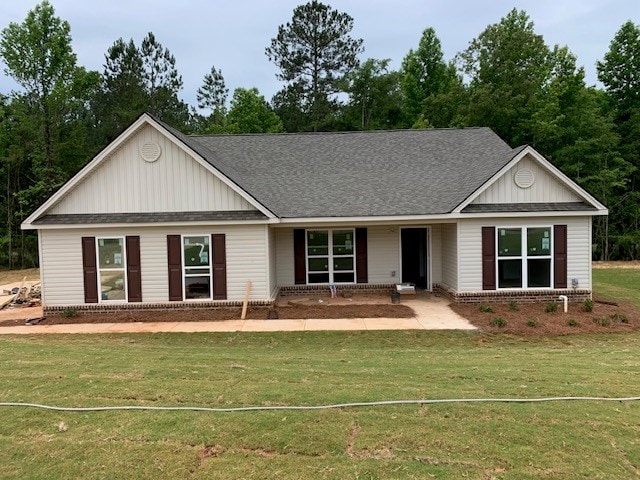 453 Riley Cir, Milledgeville, GA 31061 - ranch-style house featuring a front yard, roof with shingles, board and batten siding, and brick siding