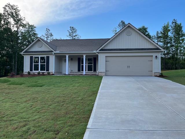 453 Riley Cir, Milledgeville, GA 31061 - single story home featuring concrete driveway, an attached garage, a front yard, covered porch, and board and batten siding