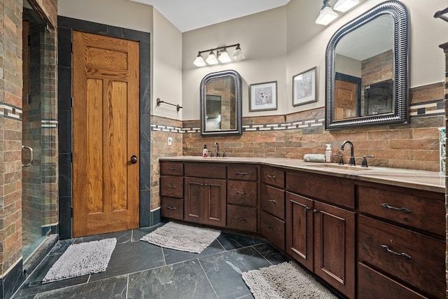 bathroom featuring vanity, walk in shower, and tile walls