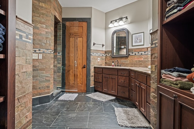 bathroom with vanity and tile walls