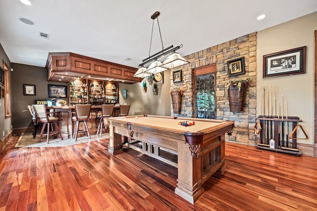 playroom featuring pool table, dark hardwood / wood-style floors, and bar