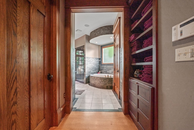 hallway with light hardwood / wood-style flooring