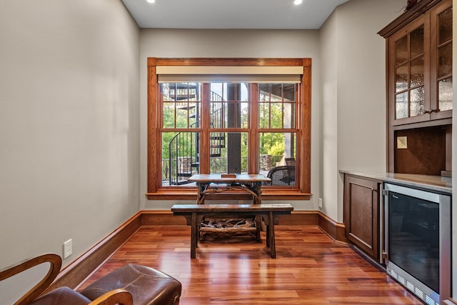 dining space with hardwood / wood-style flooring and wine cooler