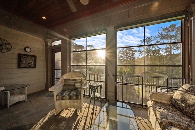 sunroom featuring beamed ceiling and wood ceiling