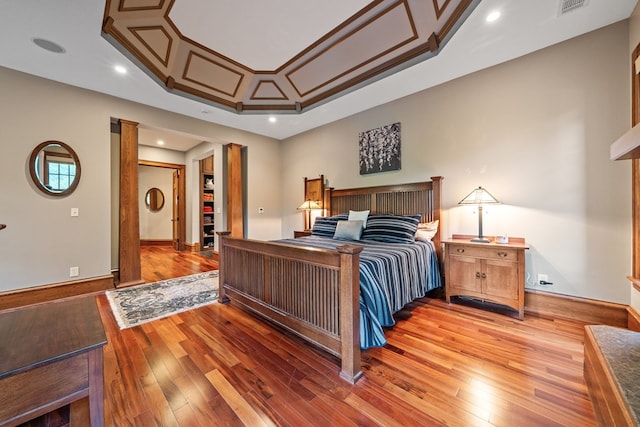 bedroom with hardwood / wood-style flooring and crown molding