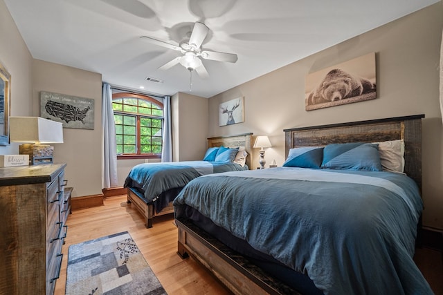 bedroom with ceiling fan and light hardwood / wood-style flooring