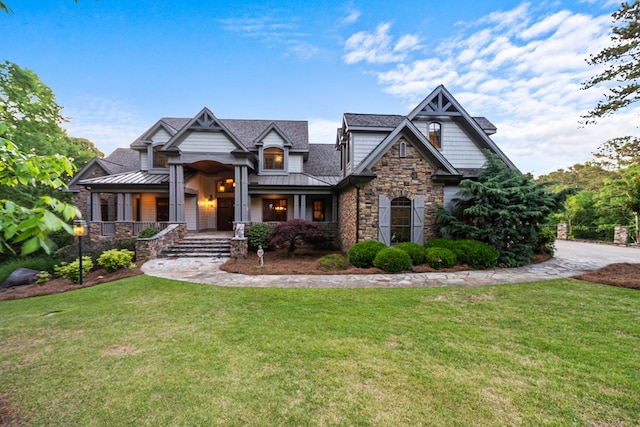 craftsman house with a porch and a front yard