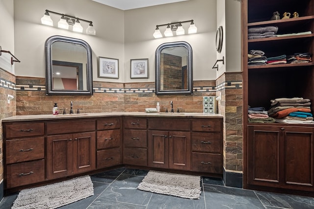 bathroom featuring vanity and tile walls