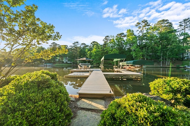 surrounding community with a water view and a dock