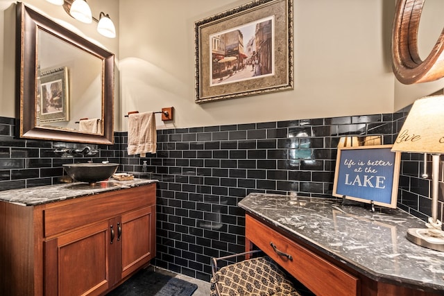 bathroom featuring vanity and tile walls