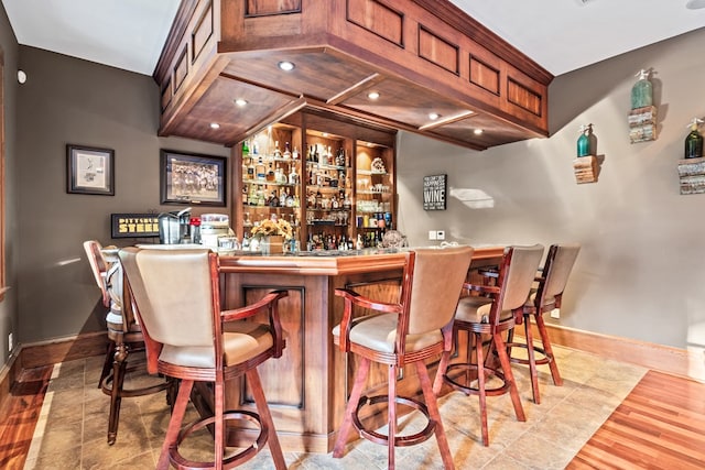 bar featuring built in features and hardwood / wood-style flooring