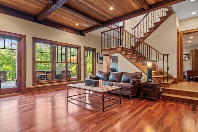 living room with beamed ceiling, wood ceiling, and hardwood / wood-style floors