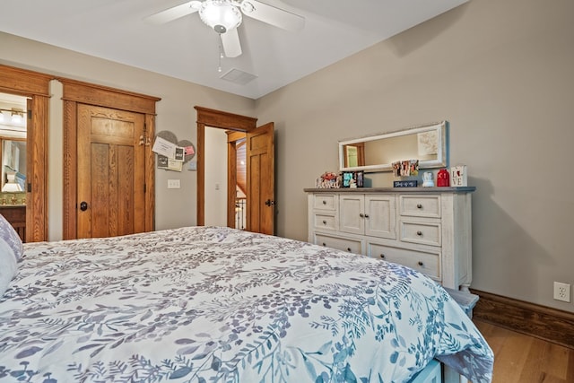 bedroom with hardwood / wood-style floors and ceiling fan