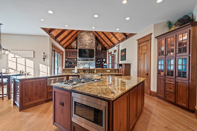 kitchen with wooden ceiling, a center island, stainless steel appliances, and vaulted ceiling