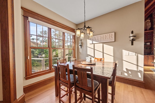 dining room with a notable chandelier and light wood-type flooring