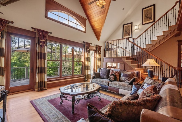 living room with wood ceiling, ceiling fan, light wood-type flooring, and high vaulted ceiling