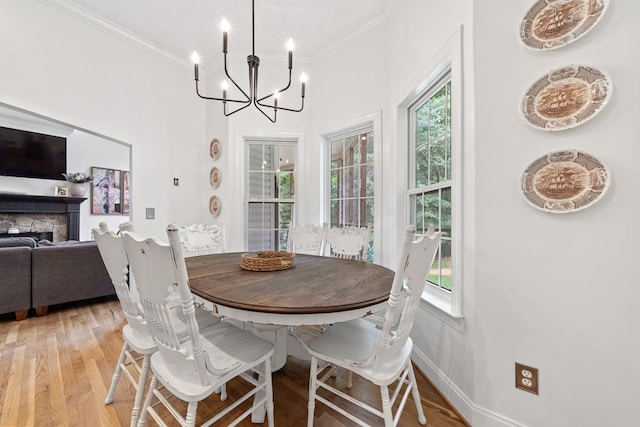 793 Greene Settlement Rd, Gray, GA 31032 - dining space featuring ornamental molding, light wood-style floors, a chandelier, and a fireplace