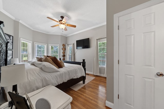 793 Greene Settlement Rd, Gray, GA 31032 - bedroom with light wood-style floors, ornamental molding, multiple windows, a textured ceiling, and ceiling fan