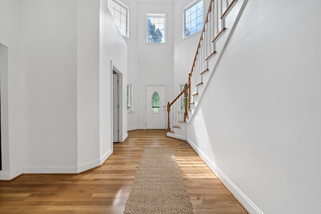 793 Greene Settlement Rd, Gray, GA 31032 - foyer with light wood-type flooring, stairs, and a towering ceiling