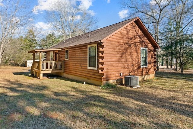 view of property exterior with central AC and a yard