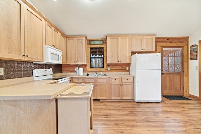 kitchen with white appliances, a healthy amount of sunlight, light brown cabinetry, sink, and light wood-type flooring