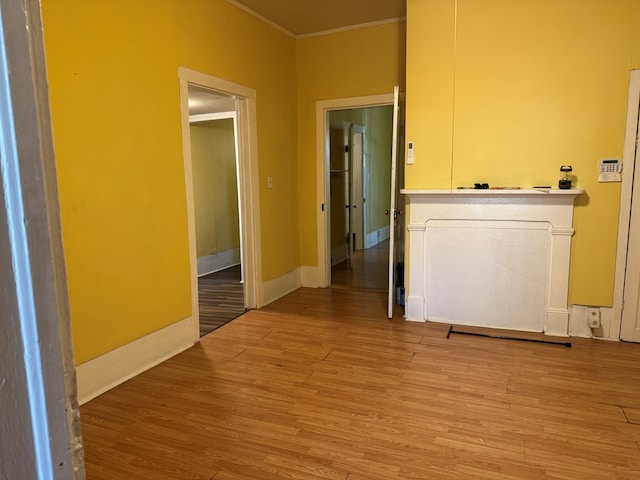 hallway featuring crown molding and hardwood / wood-style flooring