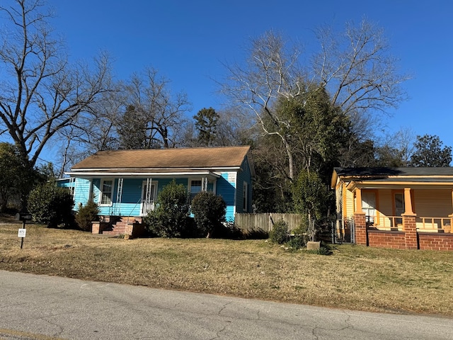 view of front of home with covered porch and a front yard