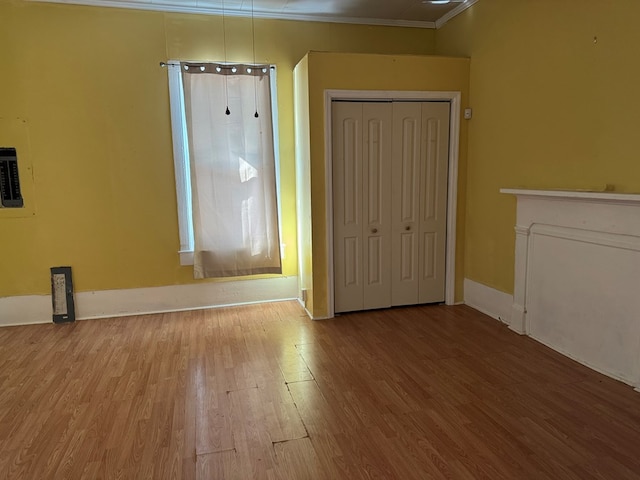 interior space featuring crown molding and light hardwood / wood-style flooring