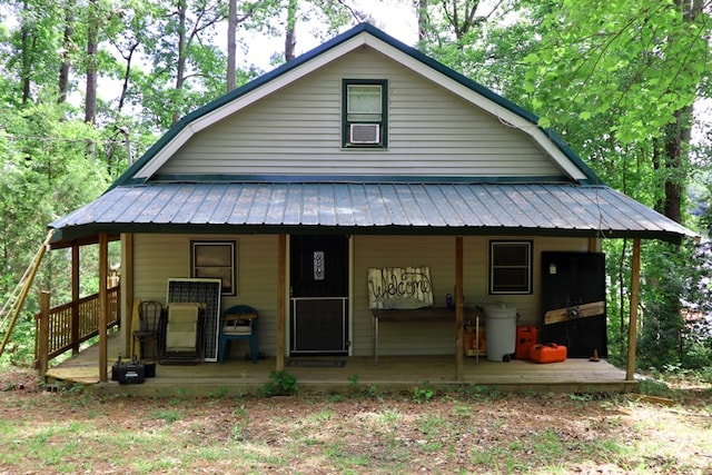 view of front facade with metal roof and a porch